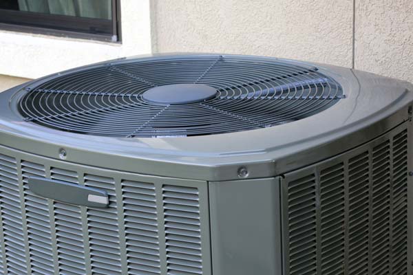 An outdoor air conditioning unit besides a window